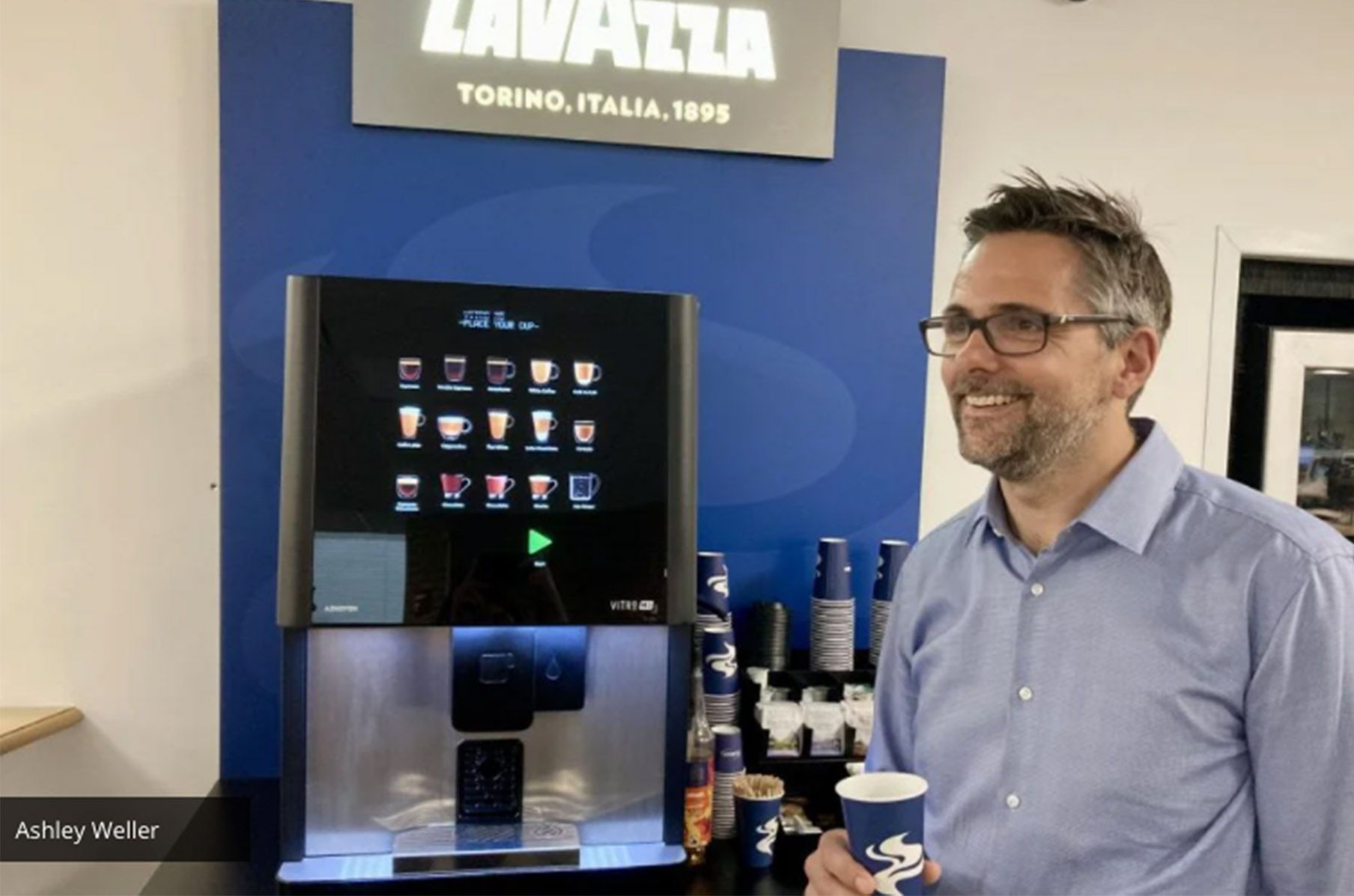 Return to Work Ashley Weller in front of our Bean to Cup Coffee Corner Coffee Machine in the office