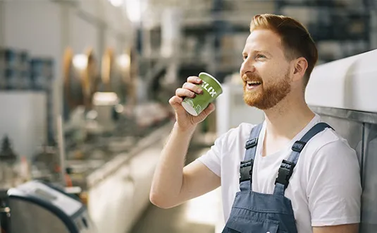 Man drinking from KLIX cup